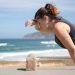 A woman rests after exercise, overlooking the ocean in Portugal's scenic seascape.